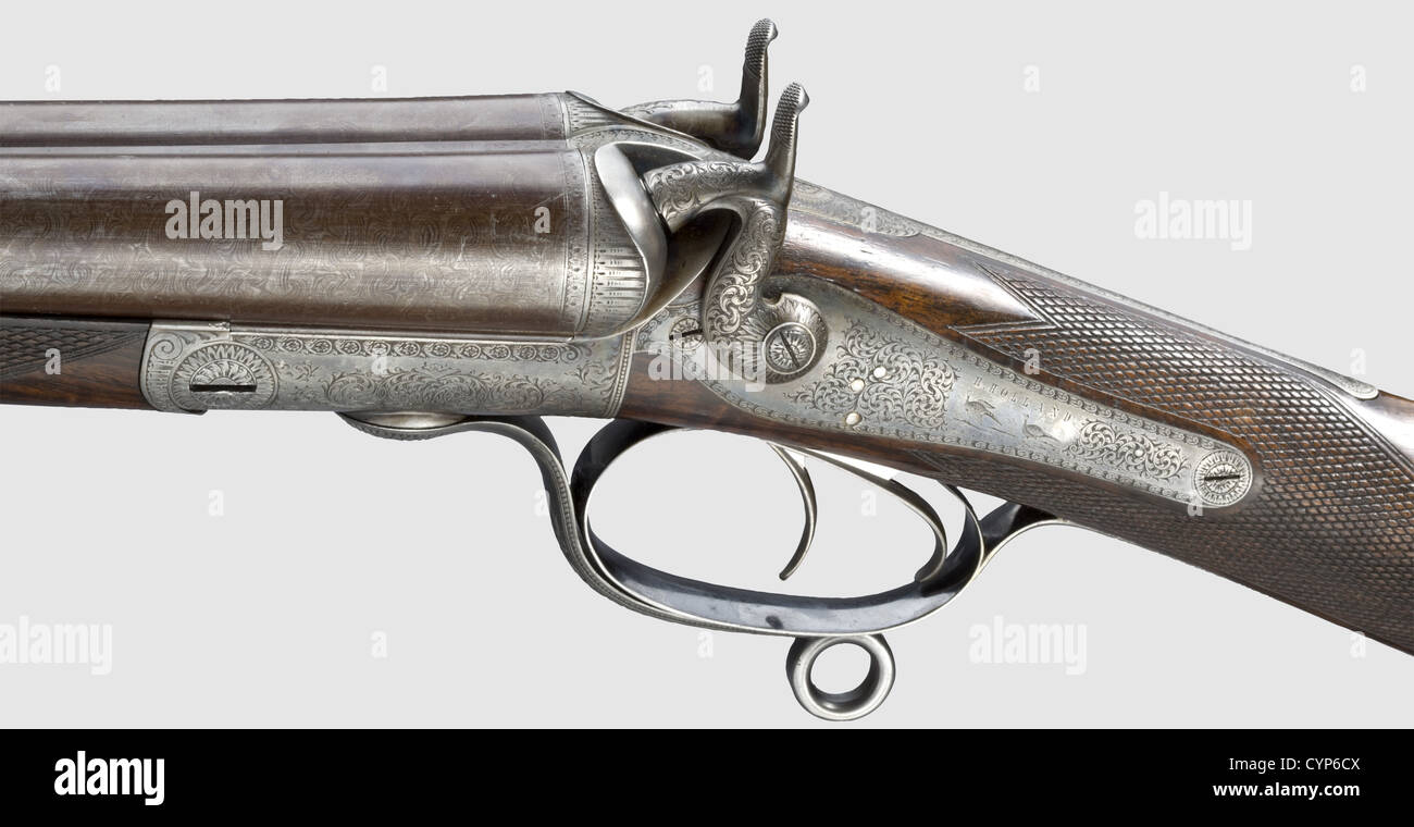 A Holland double-barrelled shotgun with hammers,London before 1876. Cal. 12/2.5',no. 1294. Browned,somewhat rubbed Damascus barrels with mirror-like bores,few small pits,cylinder bore,British nitro proof mark,rib with bead front sight and inscription: 'H. HOLLAND 98 NEW BOND ST LONDON',barrel length 76 cm. Intact,colour case-hardened action,Lancaster action,back action hammer locks,double trigger. Unobtrusive scrollwork pattern engraving. English stock of best grained root wood,monogram plaque 'BD' on lower surface,massive black horn cap,distance,Additional-Rights-Clearences-Not Available Stock Photo
