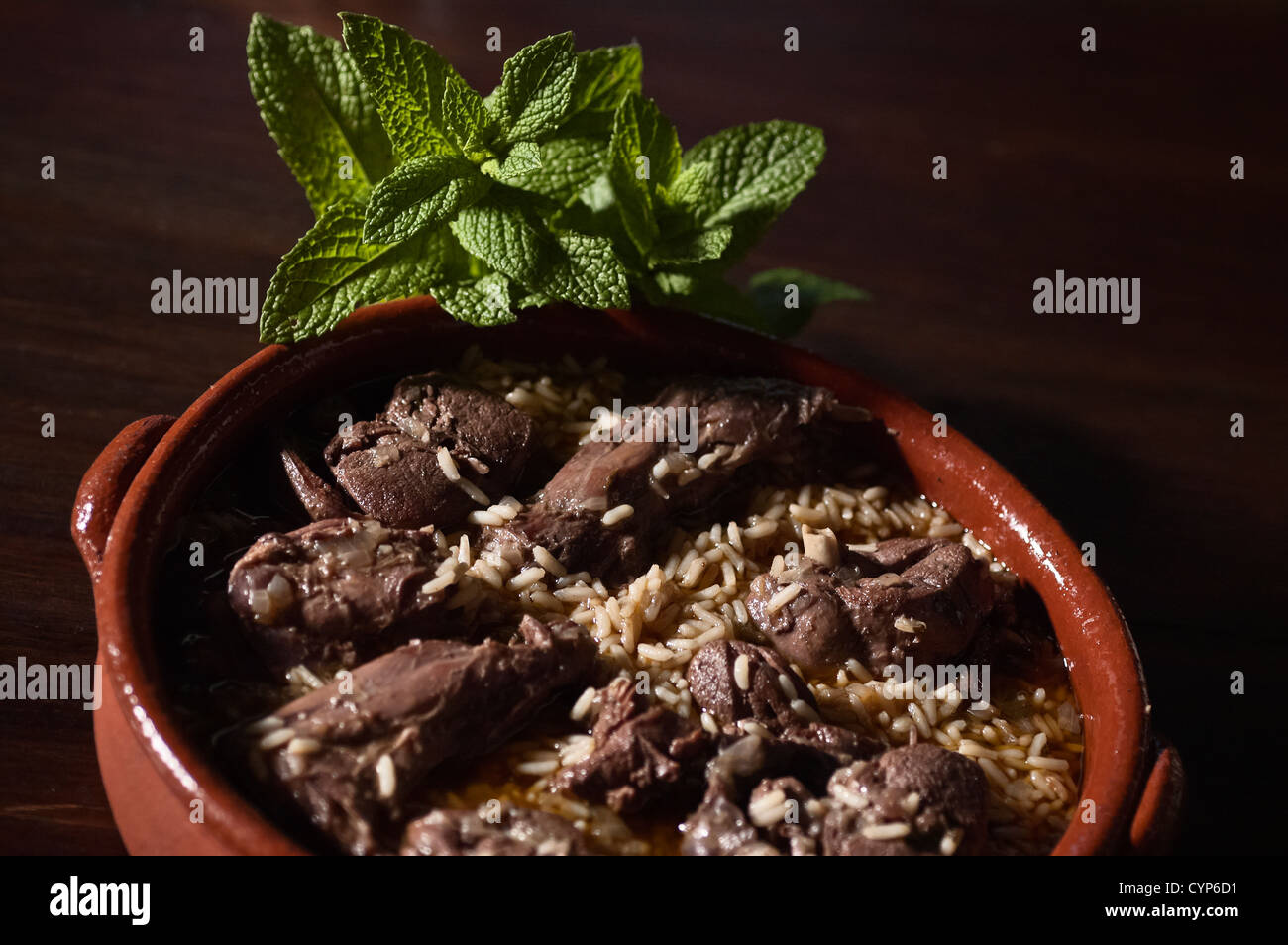Real food photographed on location in traditional portuguese restaurants, hare cooked on red wine with rice - arroz de lebre Stock Photo
