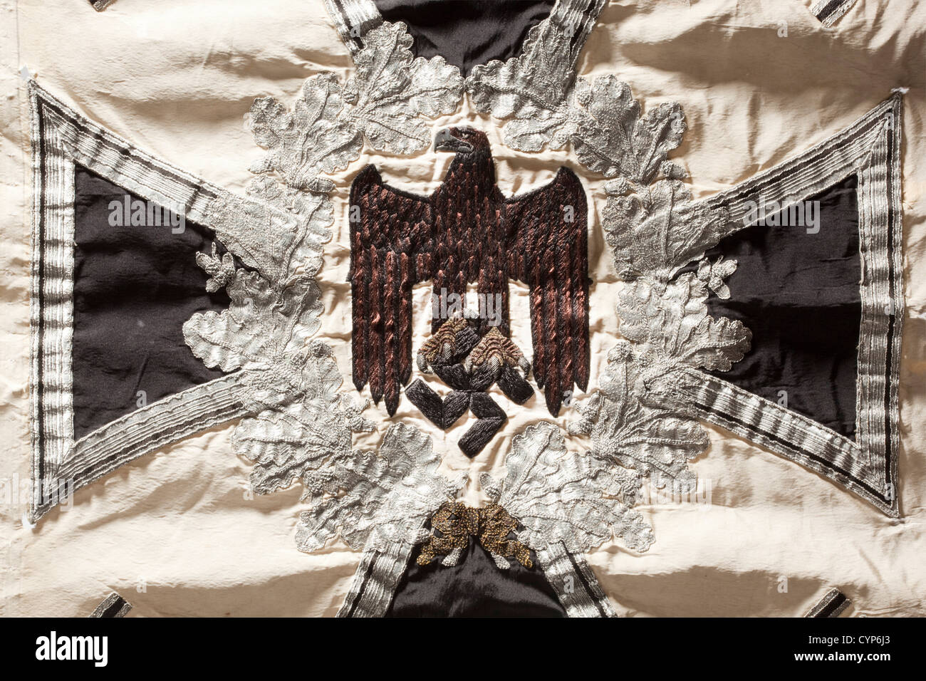 A standard,of motorised infantry. White silk with silver fringe on the three free sides. Both faces with an army eagle embroidered in black with its feathers set off in brown,the beak and claws rendered in raised gold embroidery,enclosed by a silver-embroidered oak leaf wreath on an Iron Cross,in the corners four applied swastikas. Dimensions 51 x 69 cm. Somewhat soiled,the sleeve with marks from attachment nails,slight damage caused by pulling,inscribed in pencil 'INF Regemental(sic)Banner'. A rare standard,historic,historical,1930s,1930s,20th ce,Additional-Rights-Clearences-Not Available Stock Photo