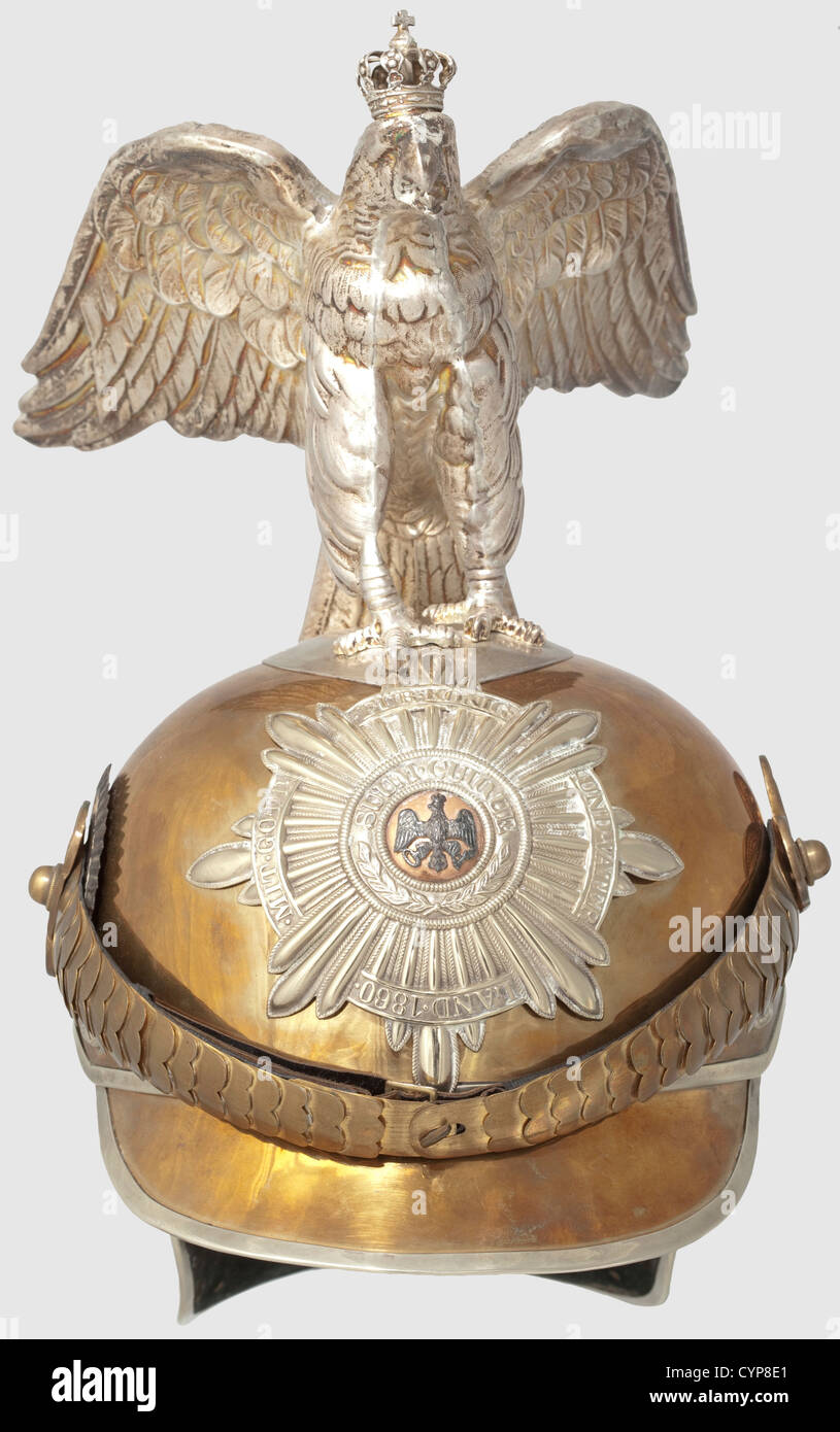 A helmet model 1894 for enlisted men,of the Garde du Corps and Guard Cuirassier regiments in parade issue. Tombak shell with nickel silver edging and domed rivets,nickel silver star with applied black eagle,convex tombak chinscales with officer's rosettes and slotted-head screws,Prussian cockade for enlisted men on the right,leather liner,the front visor lined with green leather,the neck guard with green velvet. Silvered,standing parade eagle with crown. An outstanding collector's copy possibly composed from old parts,historic,historical,19th century,Additional-Rights-Clearences-Not Available Stock Photo