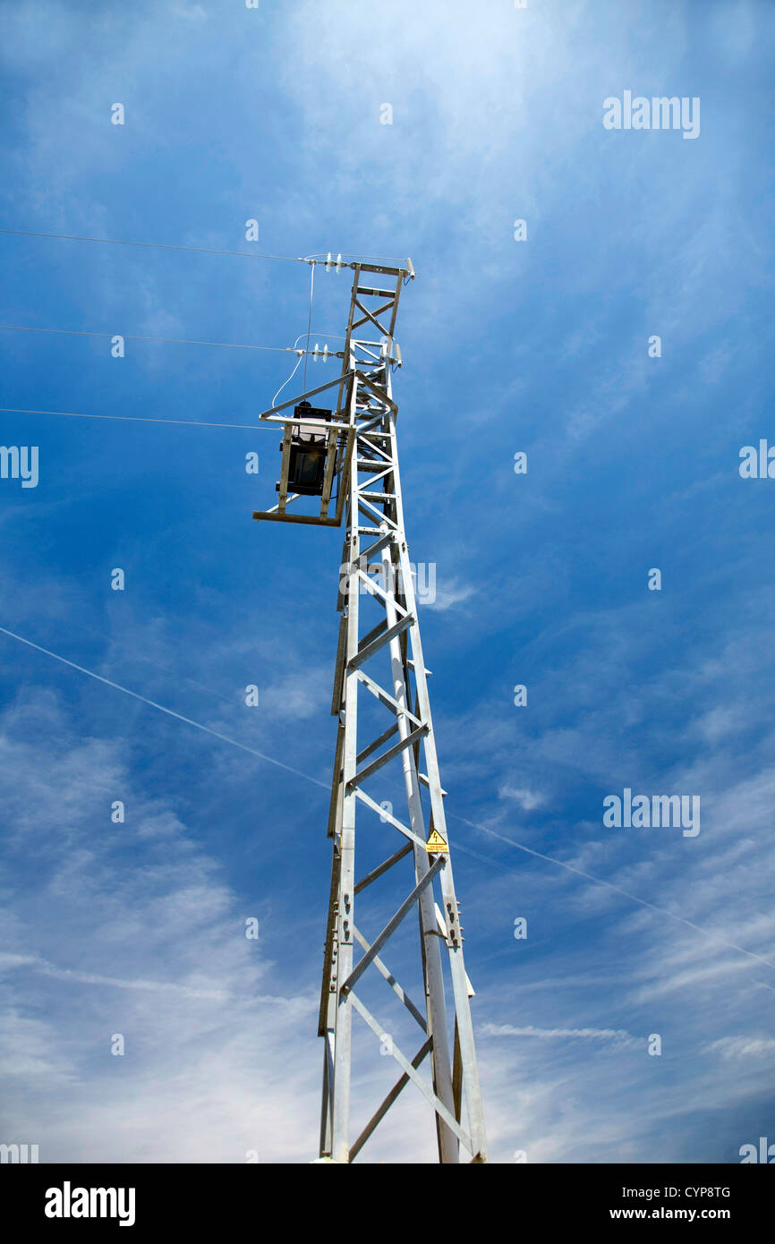 electricity tower with the blue sky behind Stock Photo - Alamy