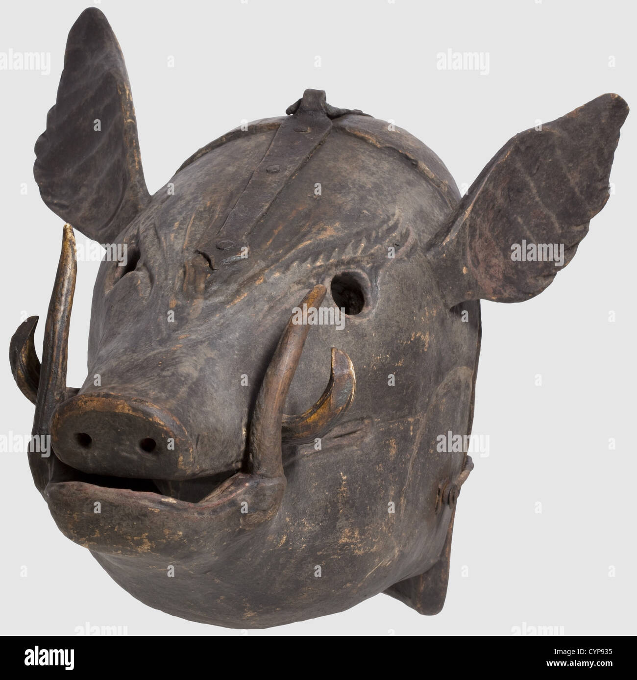 A German mask of shame,17th/18th century. Carved wooden mask in the shape of a boar's head with inserted boar's teeth,the fangs made of stag horn,with attached flaring ears. The front and back piece connected at the crown by a wrought iron hinge and with a locking hook on the side. Dark,slightly worn paint. Length 48 cm,width 40 cm. Regarding material and design a rather unusual mask of shame,probably alluding to the delinquent's 'brutish' behaviour,historic,historical,,18th century,17th century,instrument of torture,torture device,instruments of t,Additional-Rights-Clearences-Not Available Stock Photo