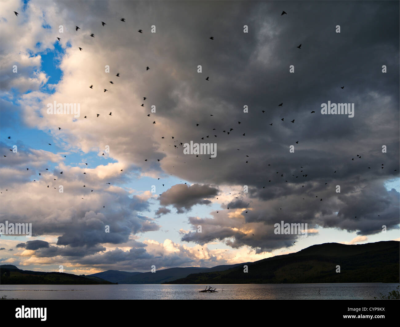 Summer stormclouds gather over lake and low hills at Loch Tay, Scotland ...