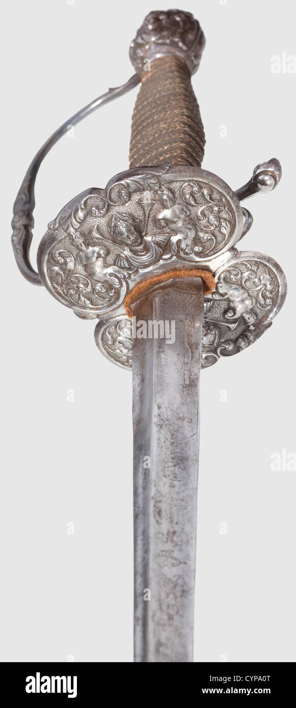 A French small-sword,early 18th century. Tapered thrusting blade of hollow-triangular section,the forte shows remnants of etched floral ornaments,slightly stained. Chiselled iron hilt with fine,half-relief decoration of antique style(handguard added later). Grip elaborately wound in copper wire with Turk's heads. Length 103 cm,historic,historical,18th century,sword,swords,weapons,arms,weapon,arm,fighting device,military,militaria,object,objects,stills,clipping,clippings,cut out,cut-out,cut-outs,melee weapon,melee weapons,metal,Additional-Rights-Clearences-Not Available Stock Photo