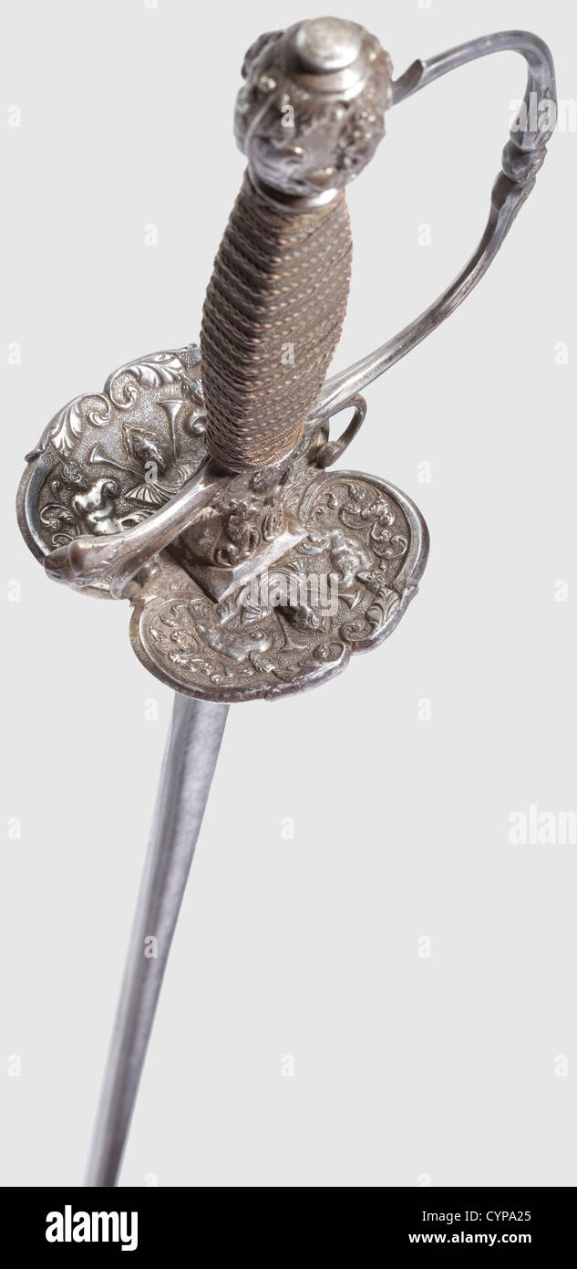 A French small-sword,early 18th century. Tapered thrusting blade of hollow-triangular section,the forte shows remnants of etched floral ornaments,slightly stained. Chiselled iron hilt with fine,half-relief decoration of antique style(handguard added later). Grip elaborately wound in copper wire with Turk's heads. Length 103 cm,historic,historical,18th century,sword,swords,weapons,arms,weapon,arm,fighting device,military,militaria,object,objects,stills,clipping,clippings,cut out,cut-out,cut-outs,melee weapon,melee weapons,metal,Additional-Rights-Clearences-Not Available Stock Photo