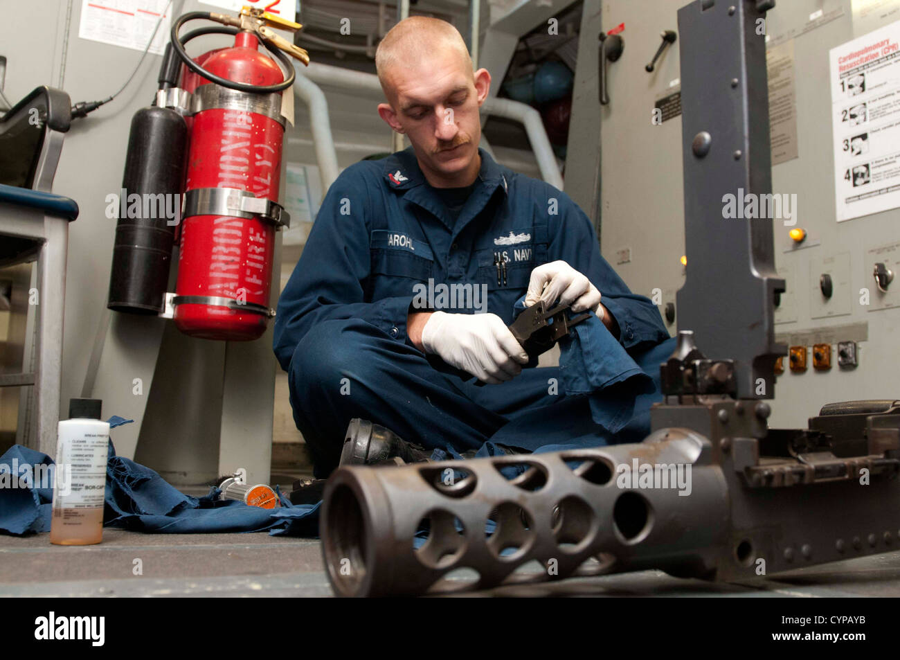 U.S. 5TH FLEET ARE OF RESPONSIBILITY (Nov. 3, 2012) Gunner's Mate 2nd Class Devon Marohl, from Oshkosh, Wis., cleans parts from Stock Photo