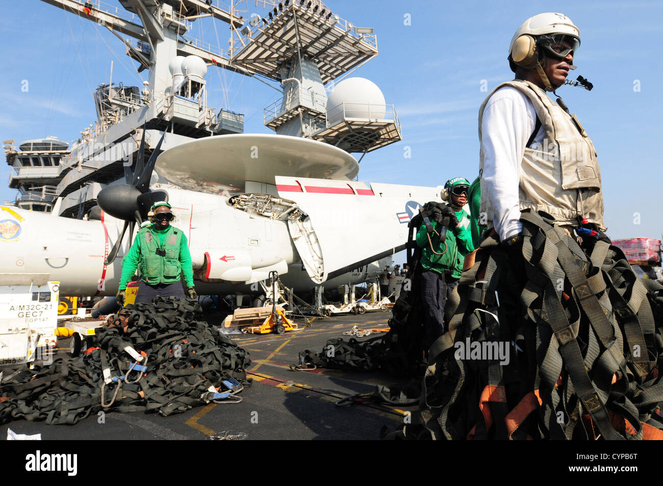 Sailors aboard the aircraft carrier USS Dwight D. Eisenhower (CVN 69) carry cargo nets during a