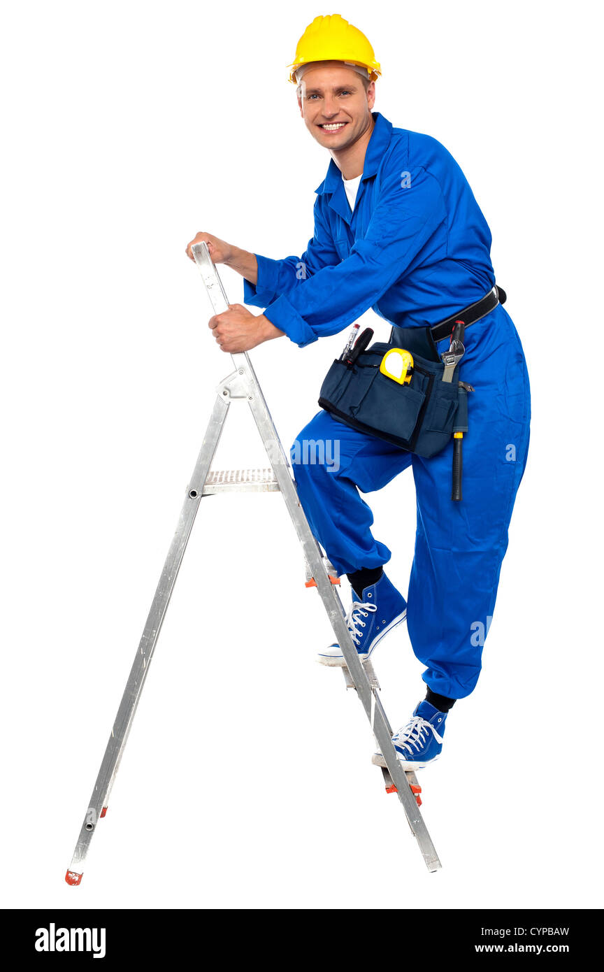 Repairman climbing up a stepladder  with tool box wrapped around his waist Stock Photo