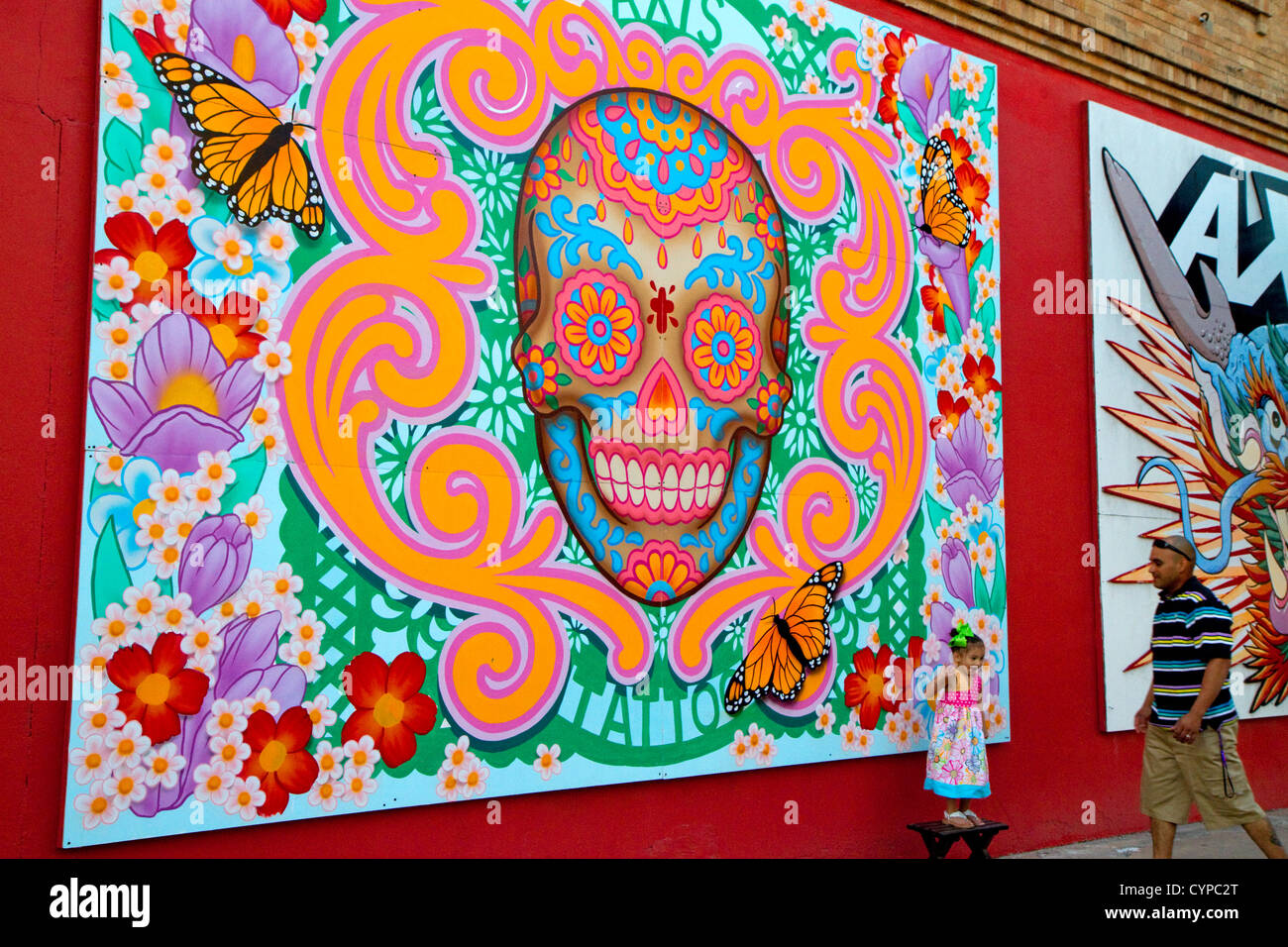 Mural on the side of a tattoo shop being used as a backdrop for a