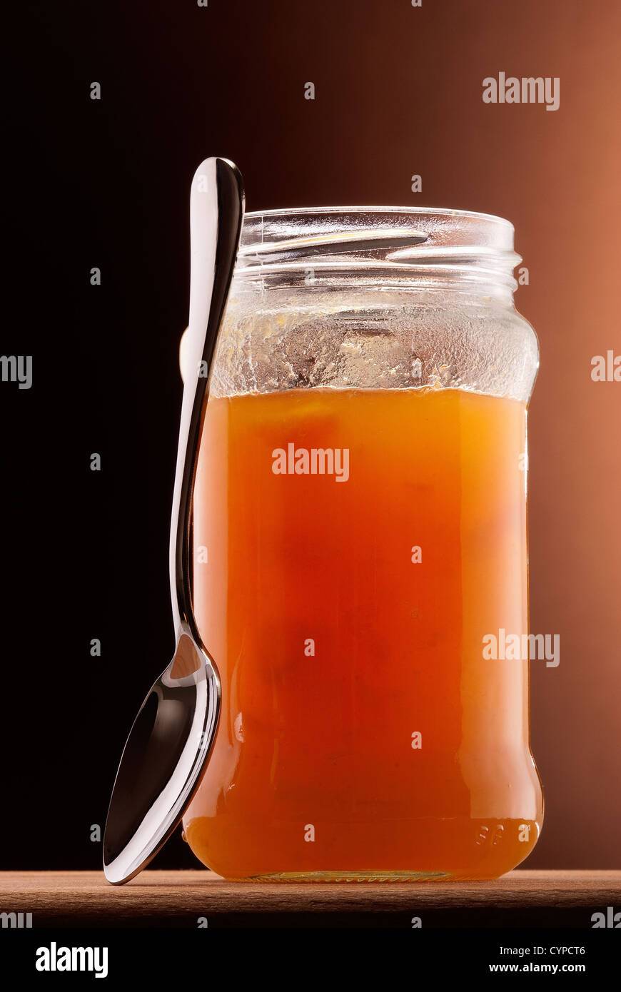 apricot jam in glass jar and tea spoon Stock Photo Alamy