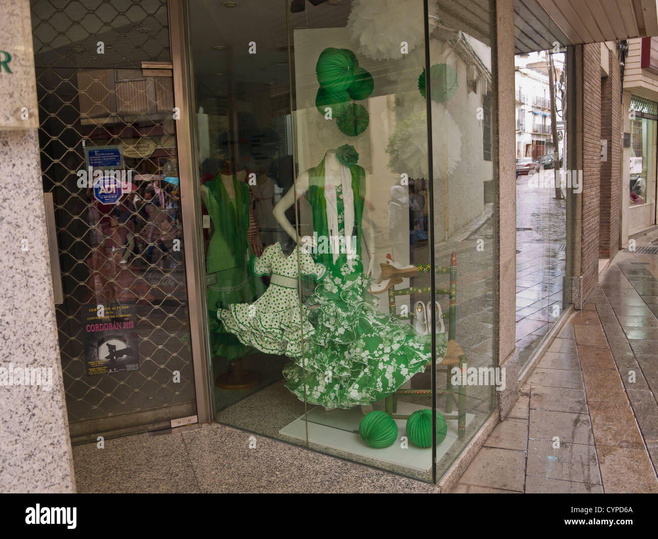 Shop window in Cordoba Andalusia Spain with traditional flamenco dress,Traje de flamenca for grown up end child Stock Photo