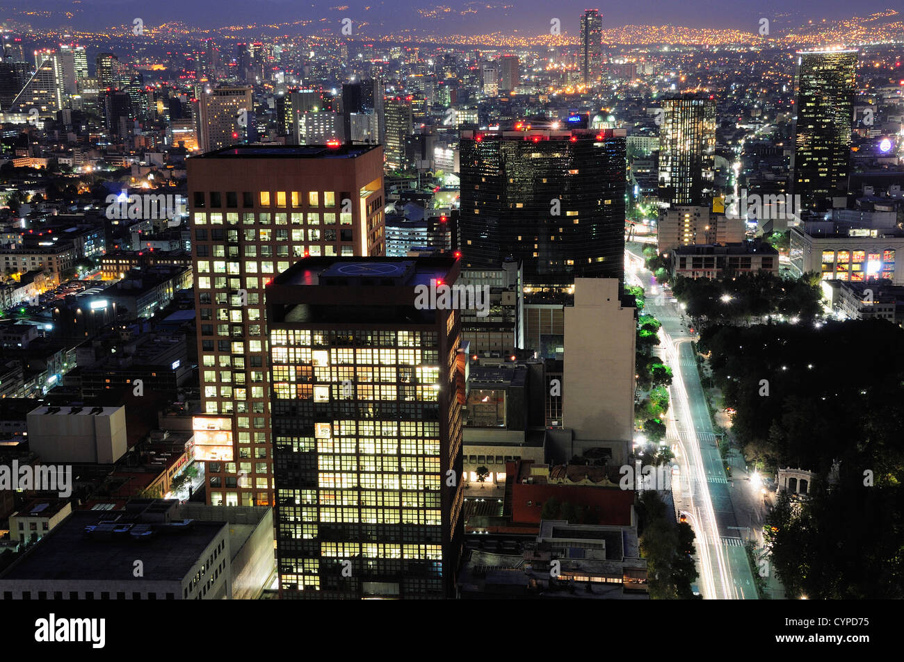 Mexico, Federal District, Mexico City, City skyline view of illuminated offices at night from Torre Latinoamericana. Stock Photo