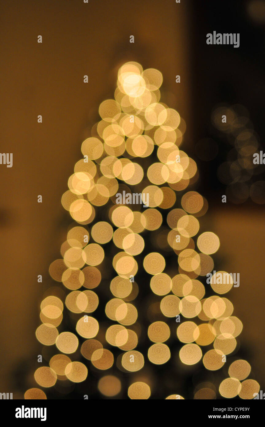 Golden White soft blurry fairy Lights on a Christmas tree Stock Photo