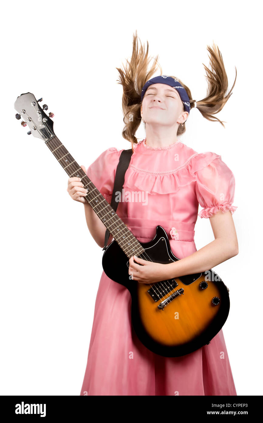 Young girl in a pink dress head-banging with an electric rock