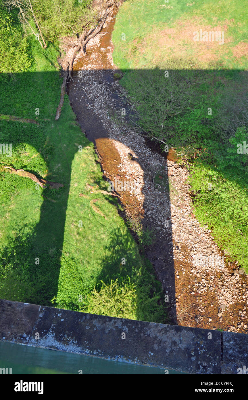 Shadow of an abandoned railway viaduct near the town Stock Photo
