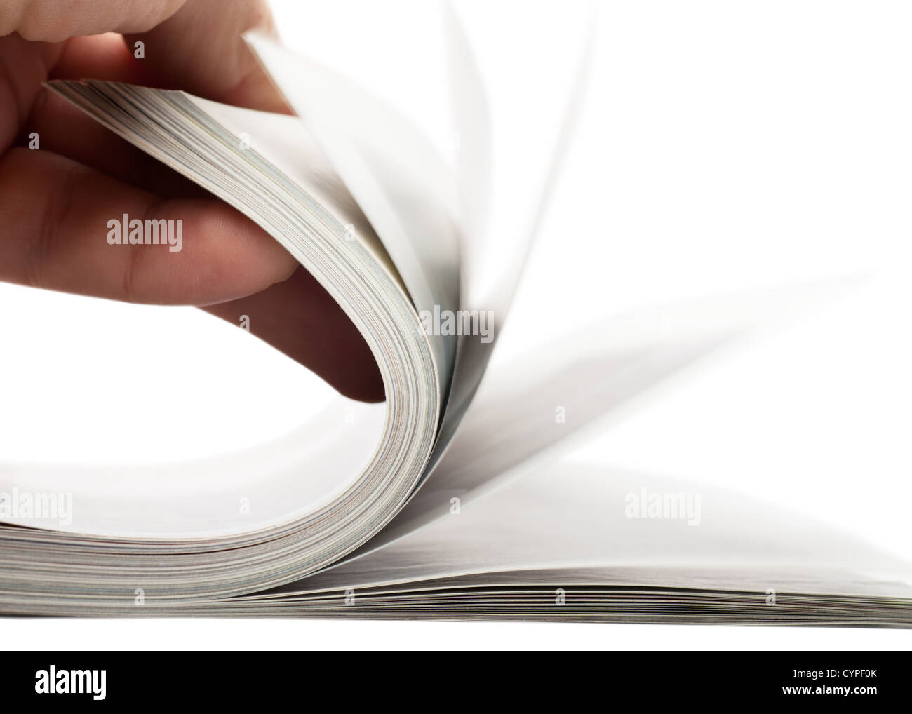 Turning over pages of thick magazine Stock Photo