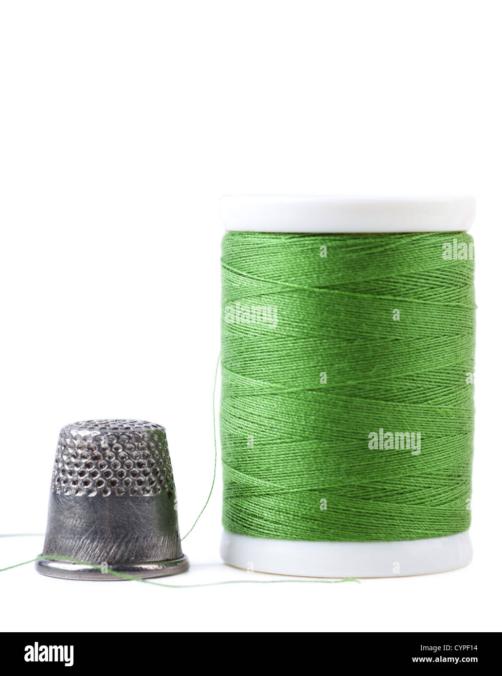 Single spool with green thread and thimble Stock Photo Alamy