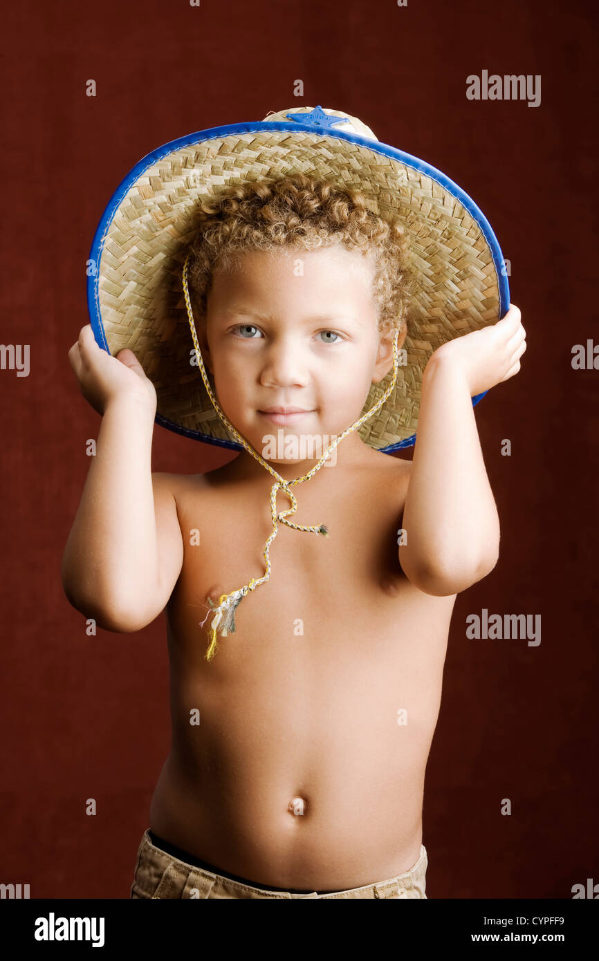 Little Boy With Curly Hair And Blue Eyes In A Sheriff Hat
