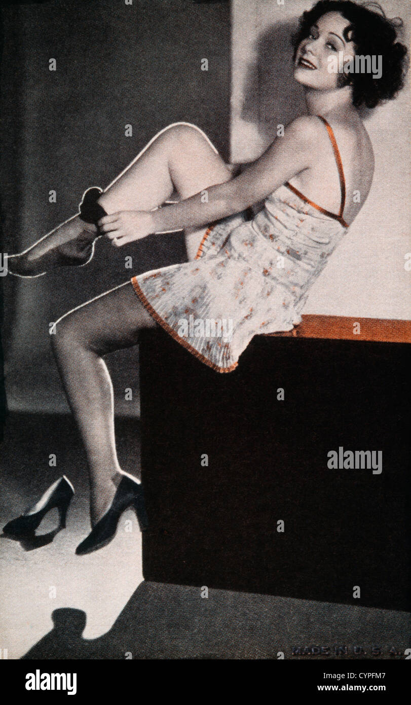Seated Woman Putting on Nylon Stockings, Pin-up Card, 1940s Stock Photo -  Alamy
