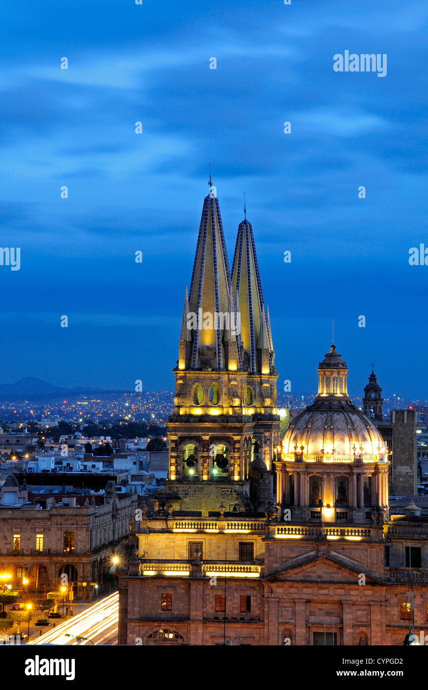 Cathedral domed roof and bell towers at night with city spread out