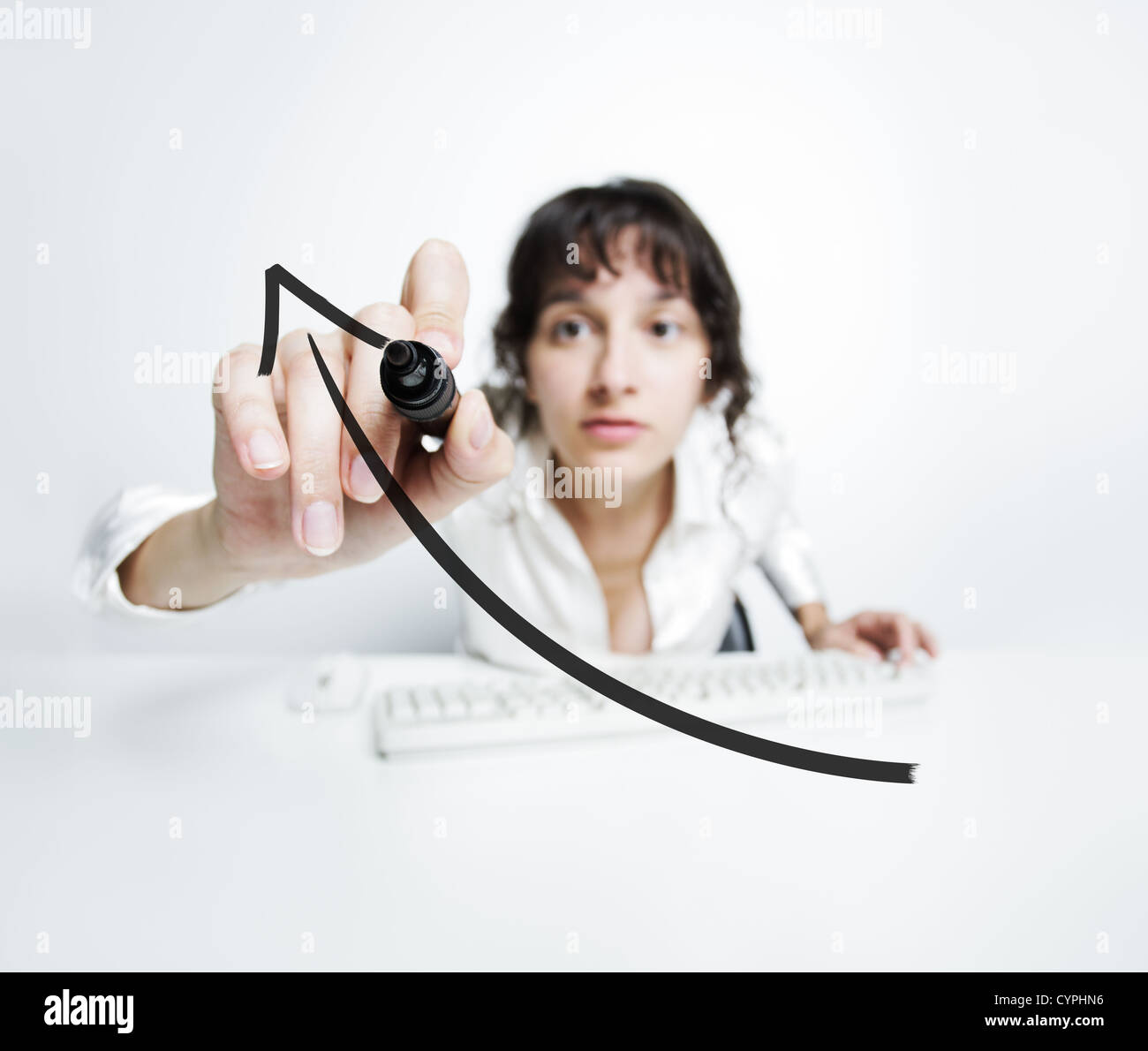 concentrated woman with a pen drawing a uptrend chart on screen Stock Photo