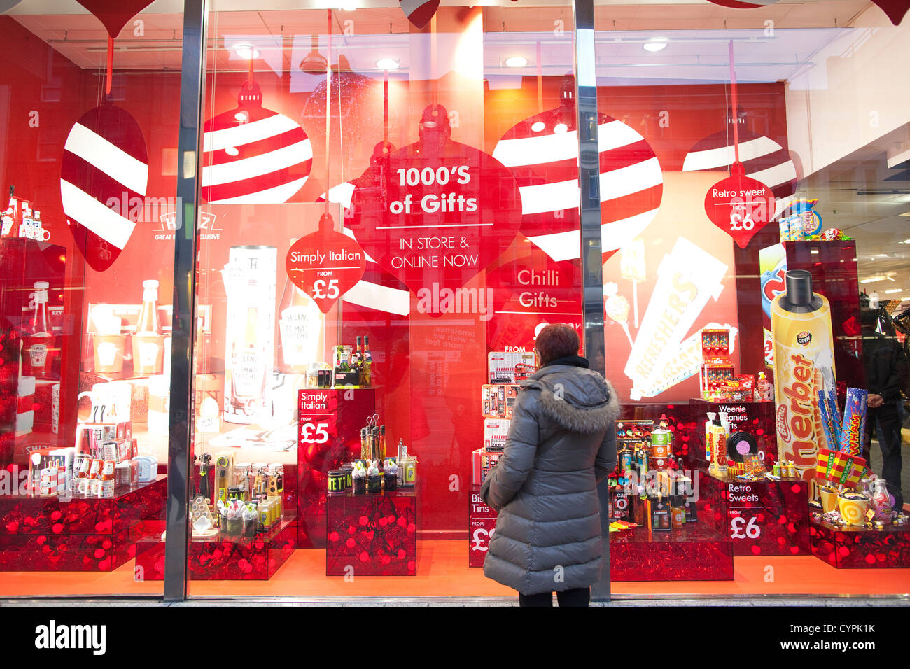 A lady looking at the Bhs (British Home Stores) Christmas window on