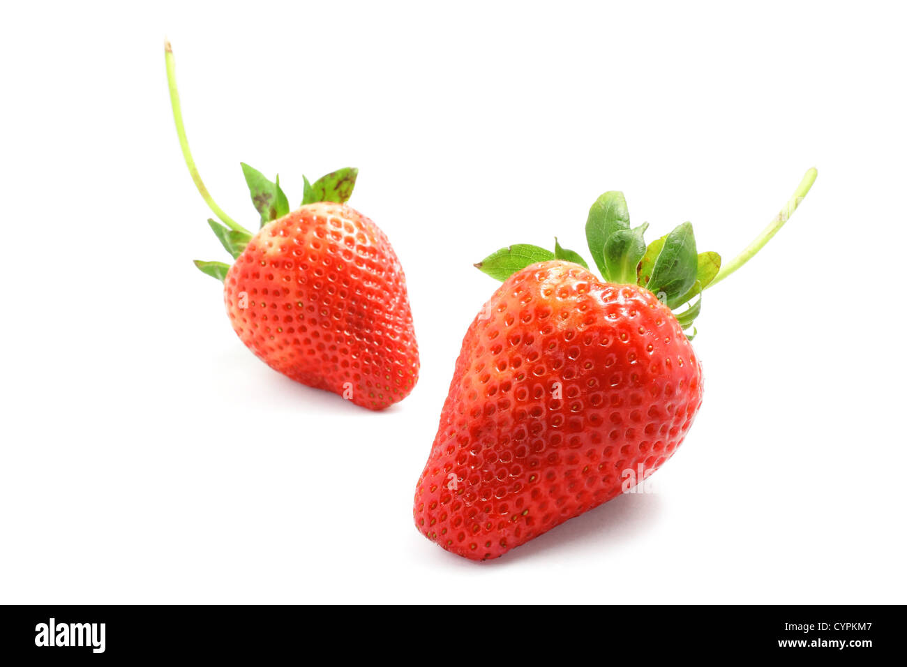 two strawberries on white background Stock Photo - Alamy