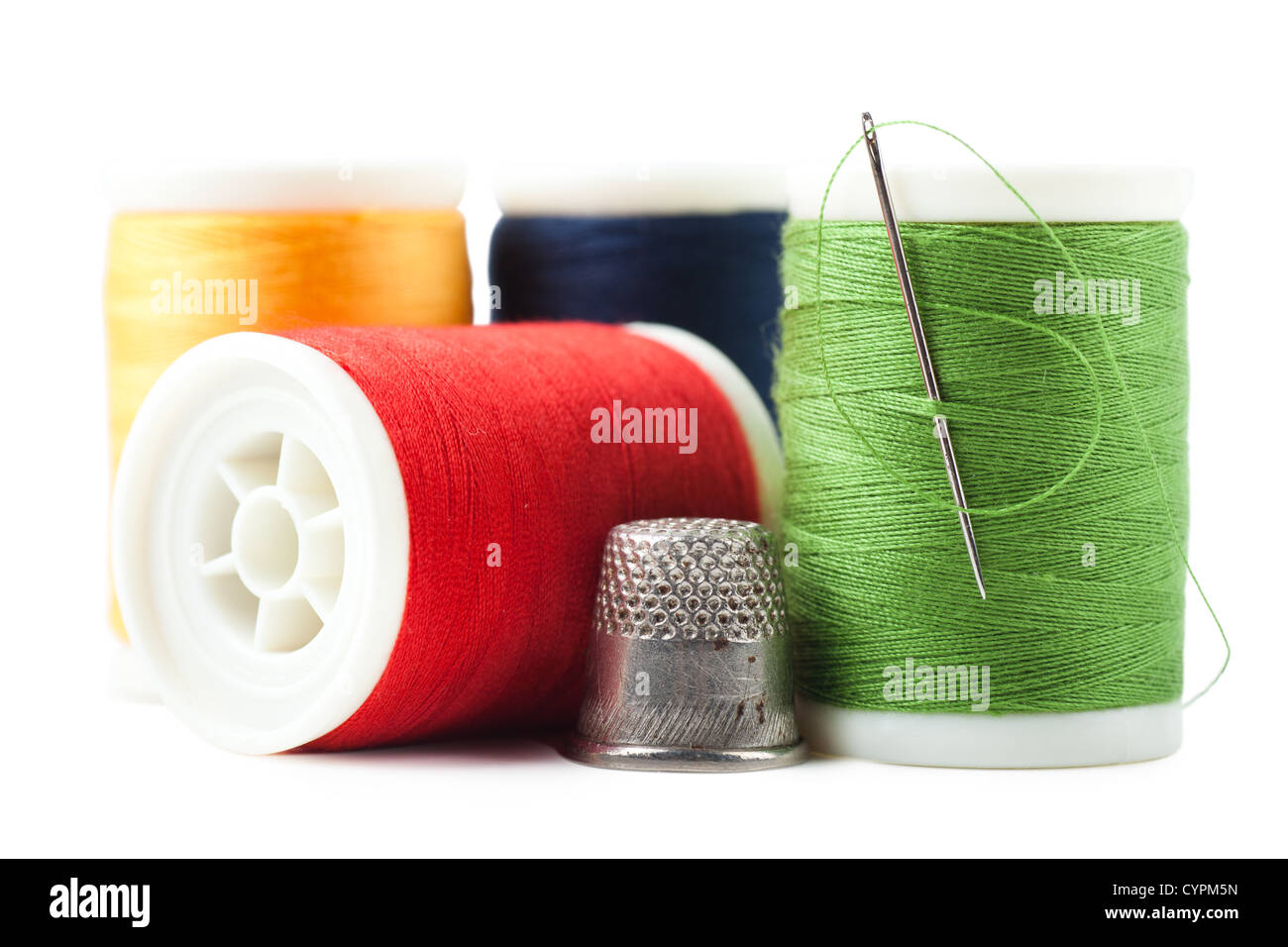 Colorful thread spools with green thread and needle Stock Photo Alamy