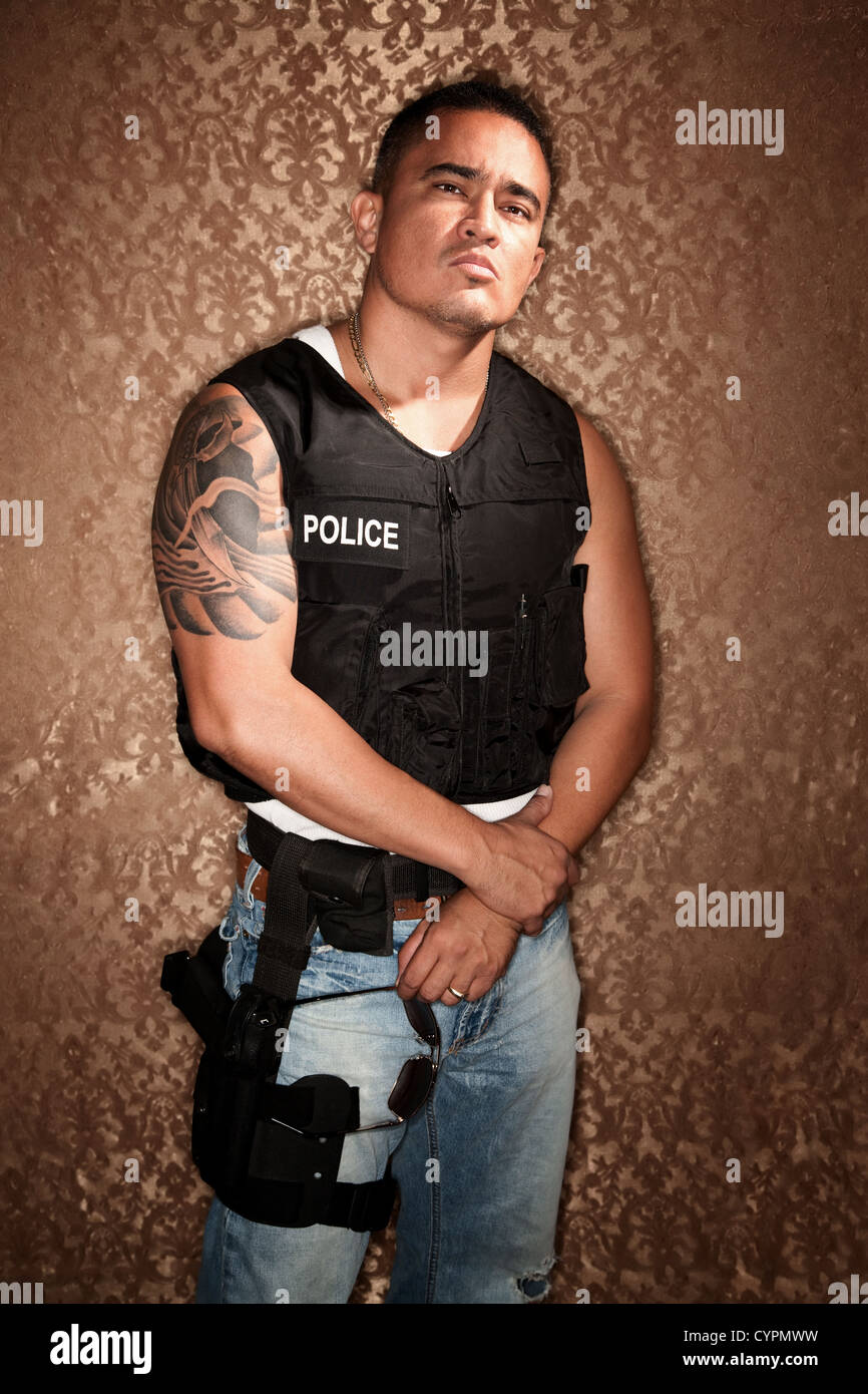 Police Officer with Bulletproff Vest on Gold Background Stock Photo