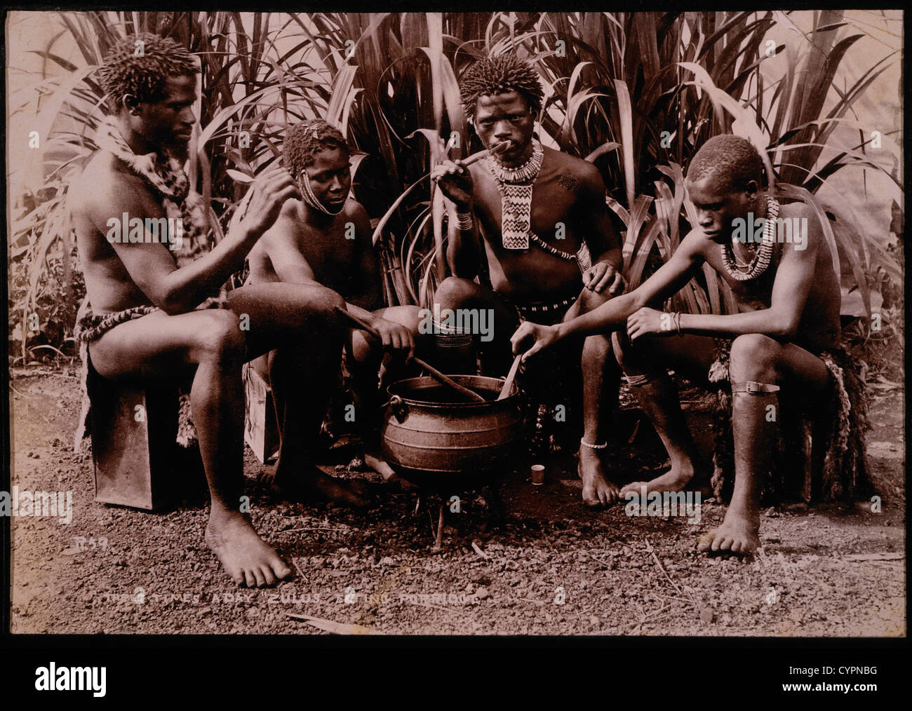 Four Zulu Men Eating From Cooking Pot, South Africa, Circa 1890 Stock Photo