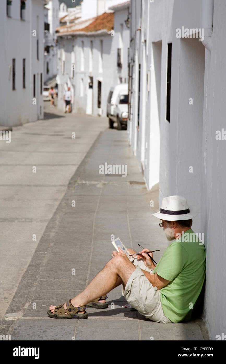 Street artist painting a typical white village Mijas Malaga Costa del Sol Andalusia Spain artista pintando calle andalusia Stock Photo