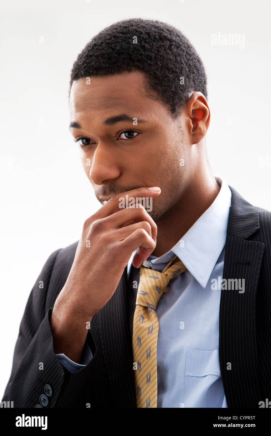 Handsome African American male in blue shirt and yellow tie and black