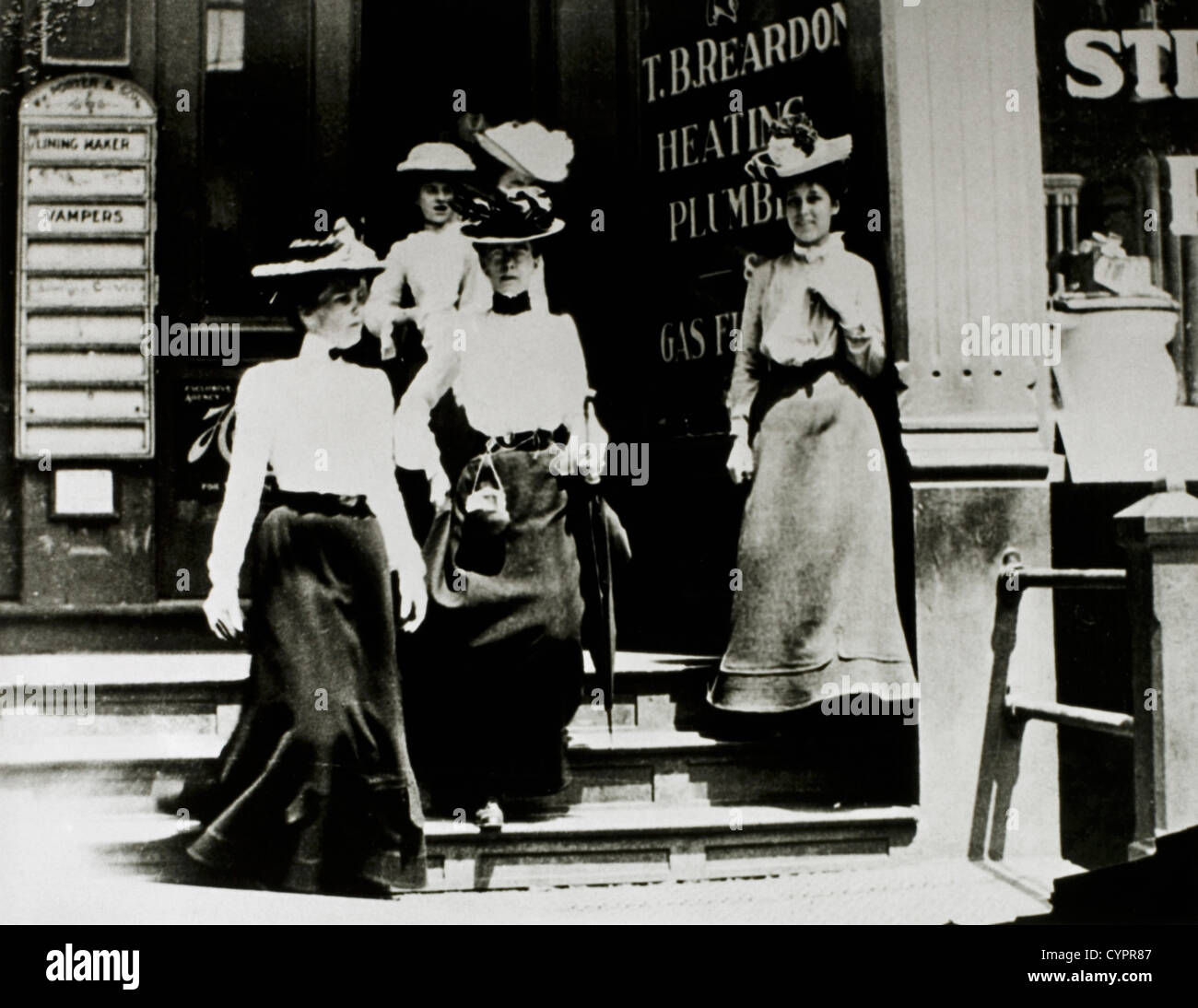 Group of Fashionable Women in Hats and Long Skirts Leaving Building, Circa 1900 Stock Photo
