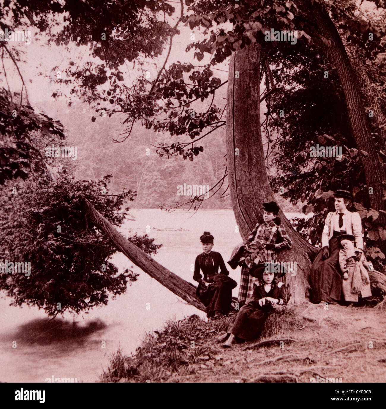 Group of Women and Children Relaxing by River, USA, Albumen Photograph, 1898 Stock Photo