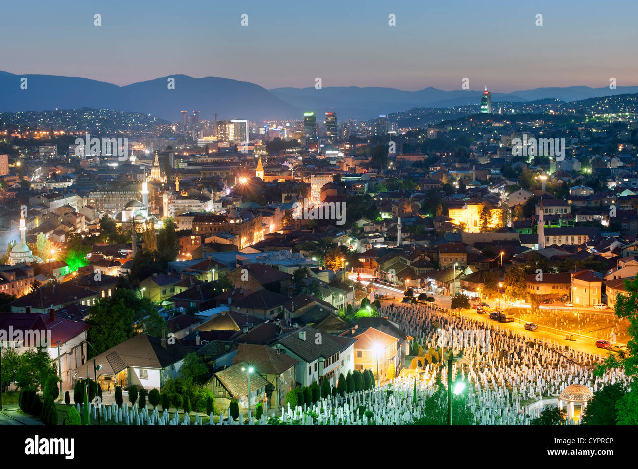 Dusk view of Sarajevo, the capital city of Bosnia and Herzegovina. In the foreground is the Martyrs memorial cemetery Kovaci. Stock Photo