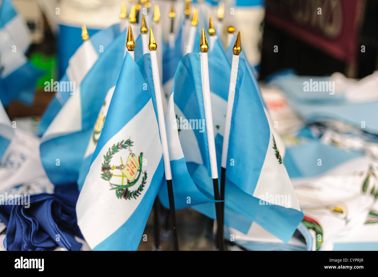 A cluster of small Guatemalan blue and white national flags for sale at the Mercado Municipal in Antigua for Guatemalan Independence Day. Stock Photo