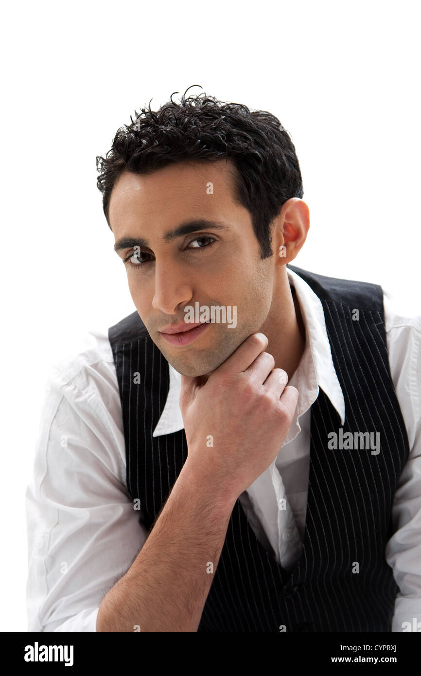 Handsome male wearing a white shirt and black pinstripe vest and hand under chin, isolated Stock Photo