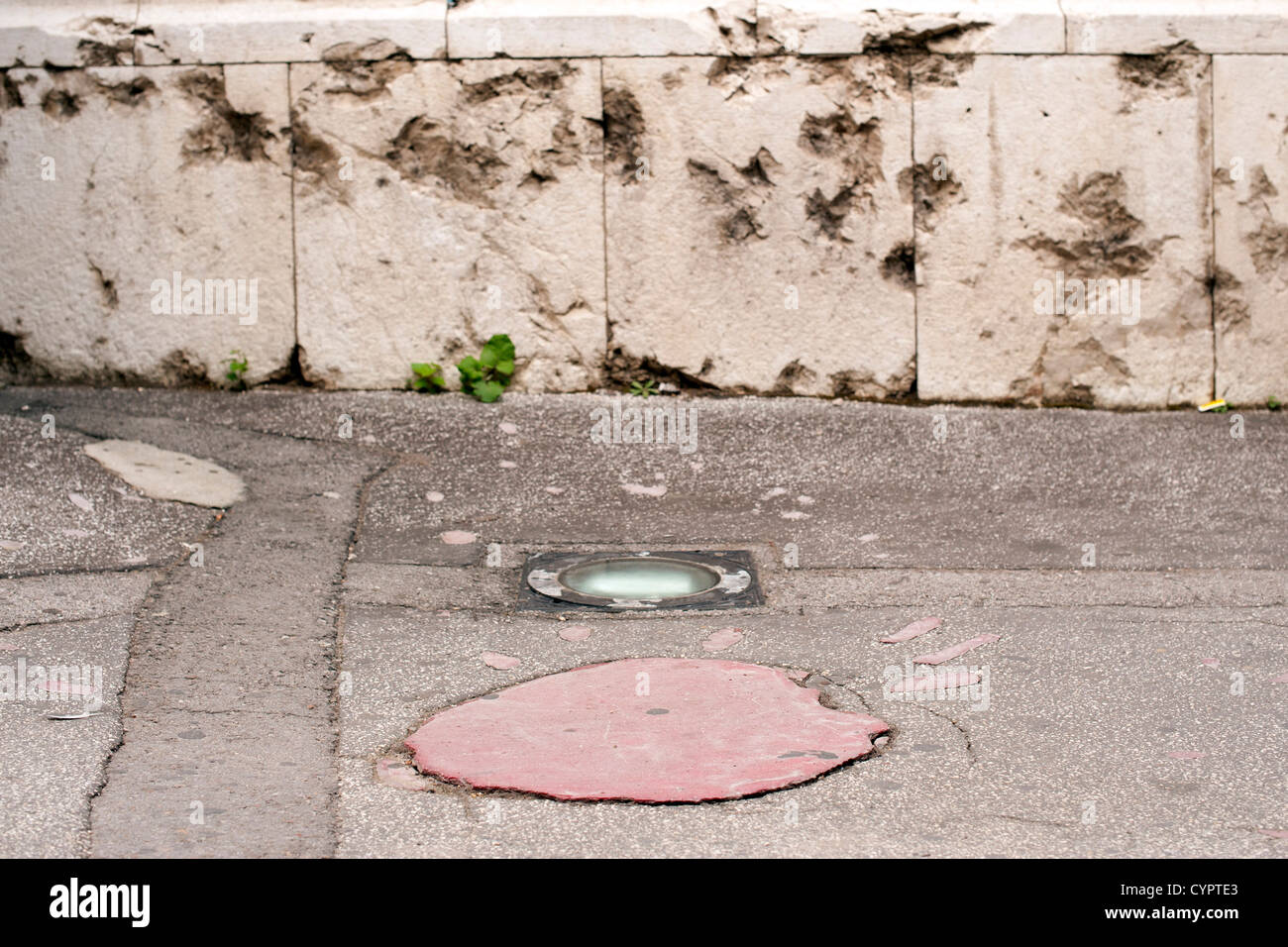 A 'Sarajevo Rose', a concrete scar caused by a mortar shell's explosion in the siege of Sarajevo during the '92-'95 conflict. Stock Photo