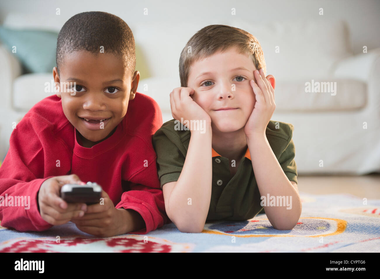 Boys watching television together Stock Photo