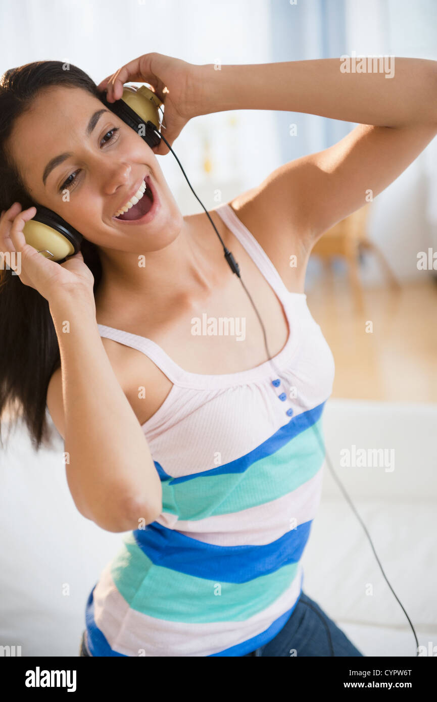 Hispanic teenager listening to music on headphones Stock Photo - Alamy