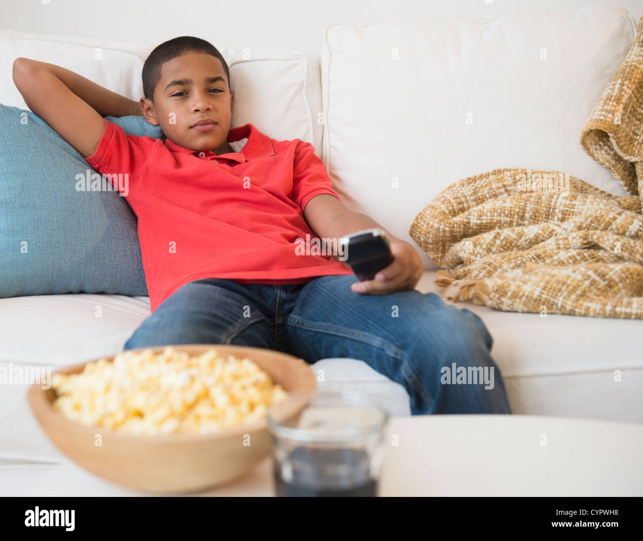 Hispanic boy watching television Stock Photo