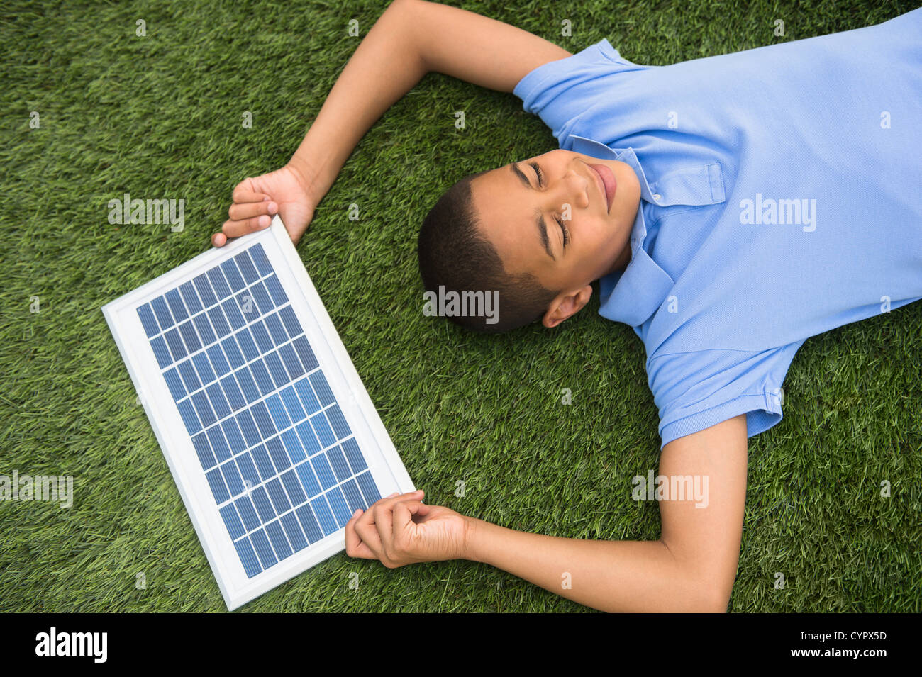 Hispanic boy holding solar panel Stock Photo