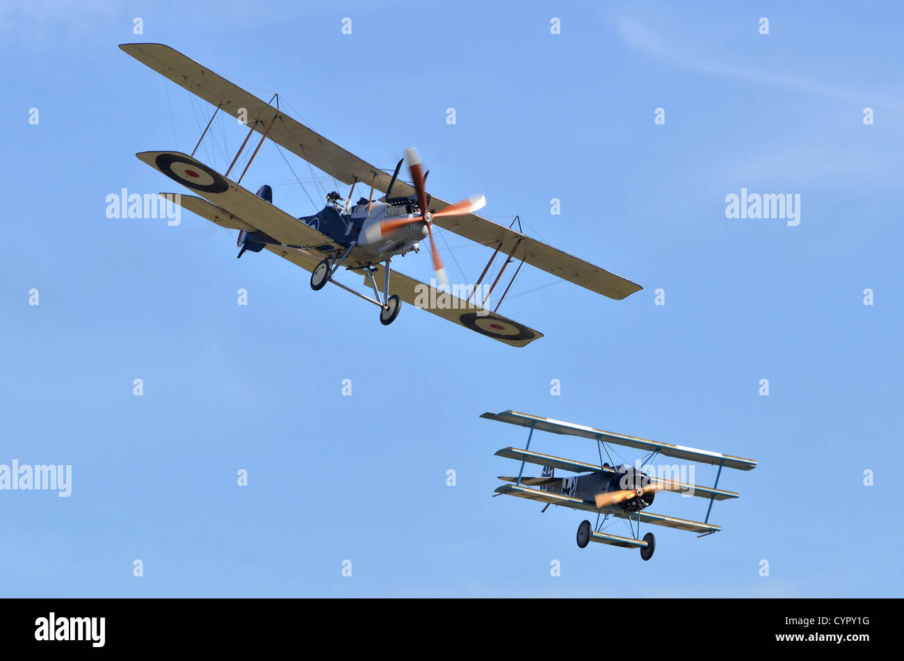 WW1 plane dogfight simulation with R.E.8 in RAF markings and Fokker DR-1 Triplane in German Air Force markings,Duxford Airshow, UK. Stock Photo
