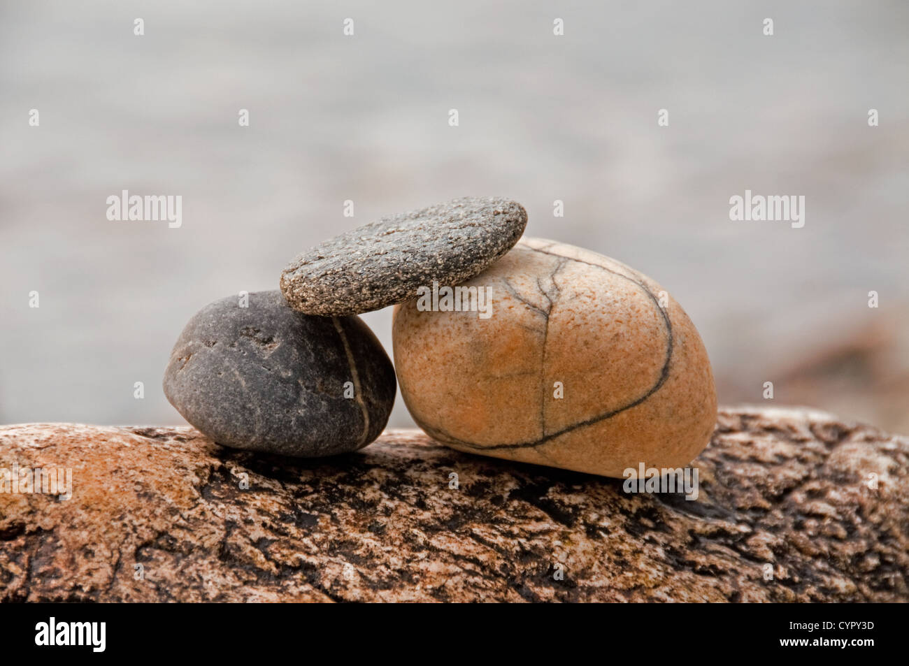 Three pebbles stack on a rock Stock Photo