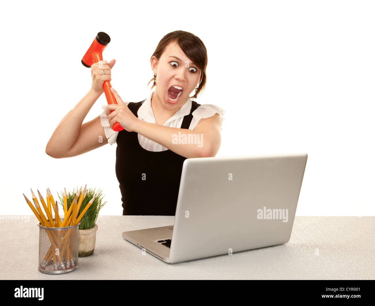 Pretty female office worker destroying laptop computer Stock Photo Alamy