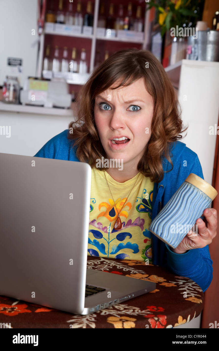 Young lady with bad internet connection at a cafe Stock Photo