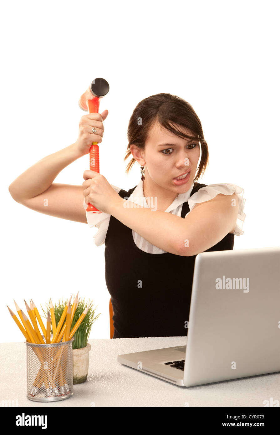 Pretty female office worker destroying laptop computer Stock Photo Alamy
