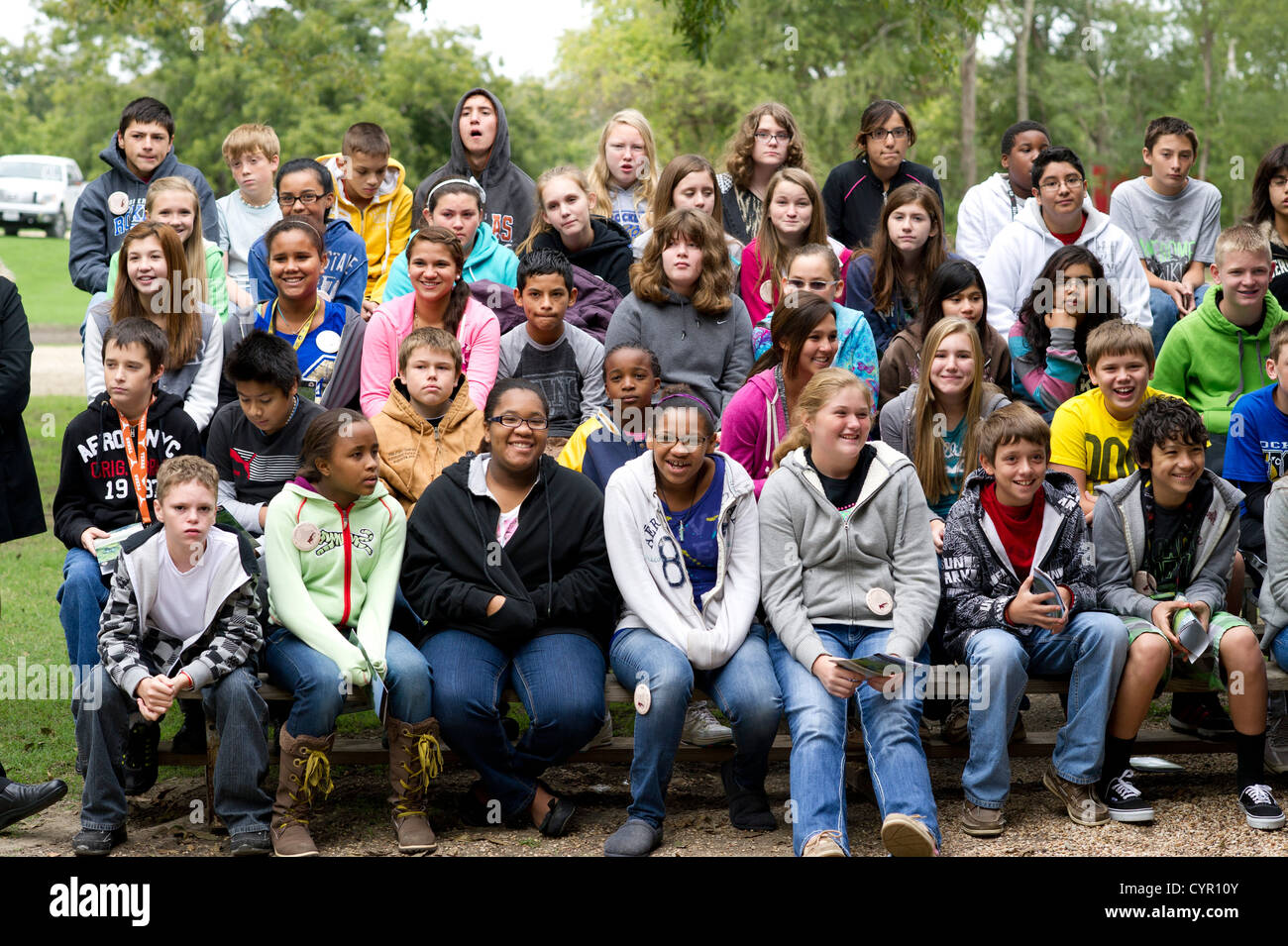 Junior high school students listen to a speaker during a field trip to