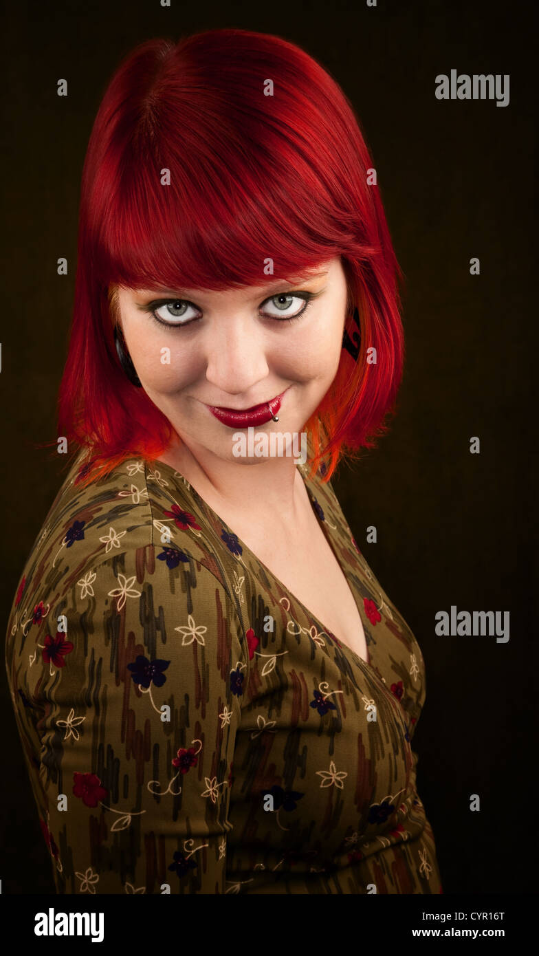 Pretty punky girl with brightly dyed red hair Stock Photo