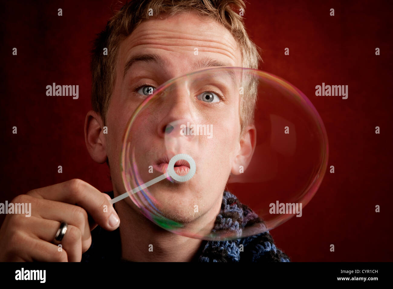 Handsome young blonde man blowing a bubble Stock Photo Alamy